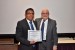 Dr. Nagib Callaos, General Chair, giving Eng. Eduardo Juan Diego the best paper award certificate of the session "Sistemas, Cibernética e Informática I." The title of the awarded paper is "Análisis de Estaciones Climatológicas e Hidrométricas de la Presa Cointzio."